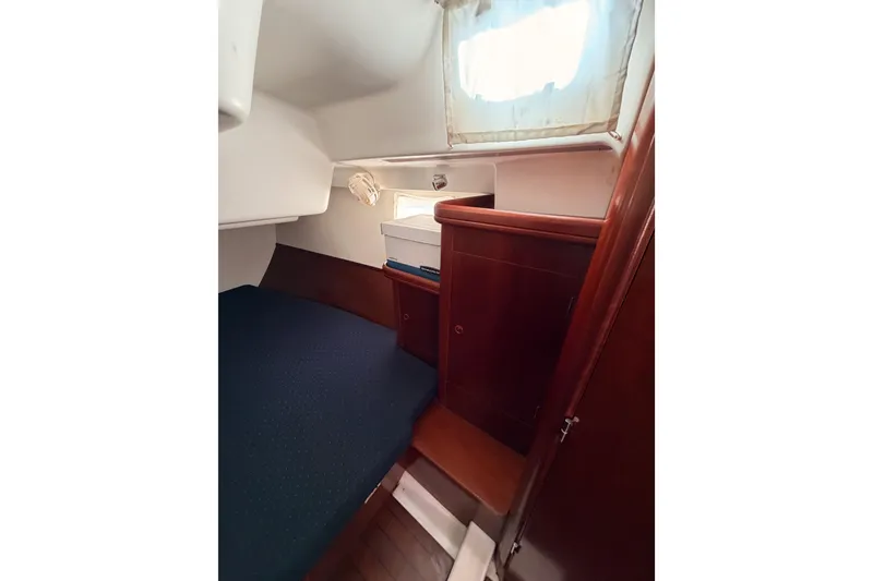Slide: The Image of 2003 Beneteau Oceanis Clipper 473 cabin interior with wooden cabinetry and bed. - 44