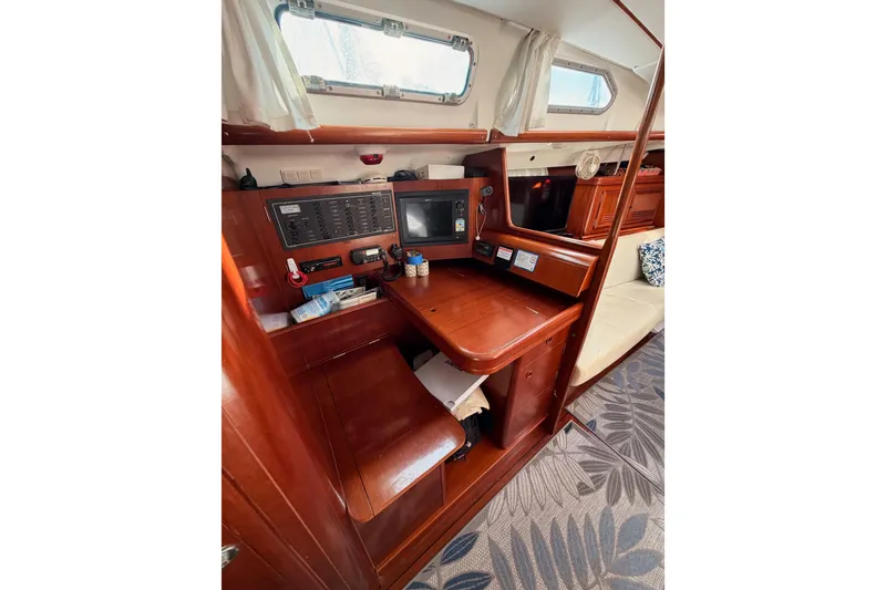 Slide: The Image of Interior of 2003 Beneteau Oceanis Clipper 473 yacht with navigation station and wooden finish. - 47