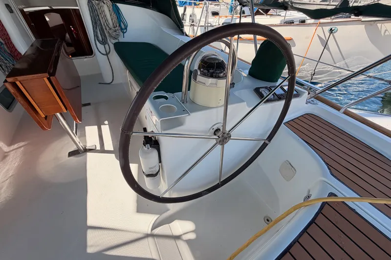 Slide: The Image of Cockpit of 2003 Beneteau Oceanis Clipper 473 sailboat with steering wheel and seating. - 5
