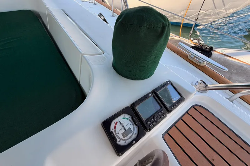 Slide: The Image of Cockpit of 2003 Beneteau Oceanis Clipper 473 with navigation instruments and green cover. - 6