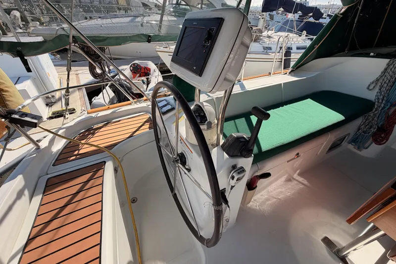 Slide: The Image of Cockpit of 2003 Beneteau Oceanis Clipper 473 sailboat with steering wheel and navigation equipment. - 7
