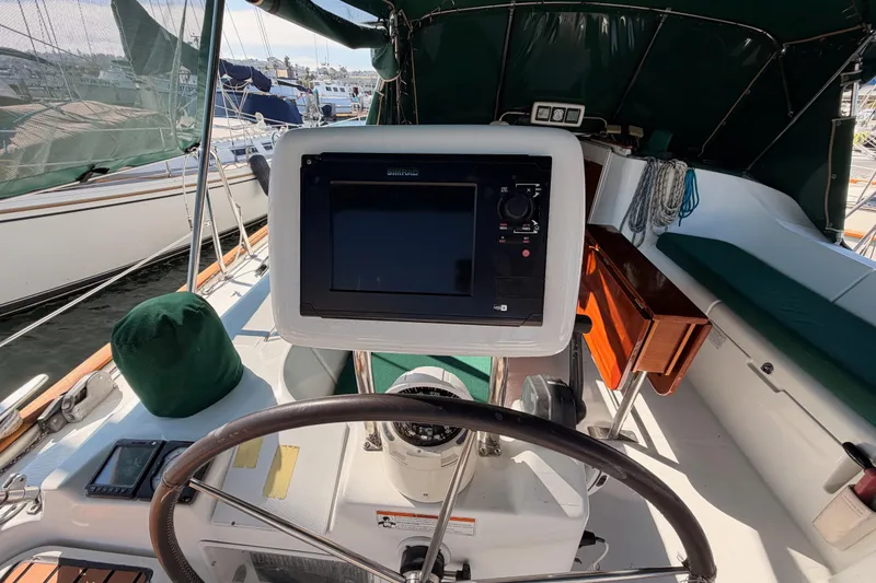 Slide: The Image of Cockpit of 2003 Beneteau Oceanis Clipper 473 with navigation equipment and steering wheel. - 8