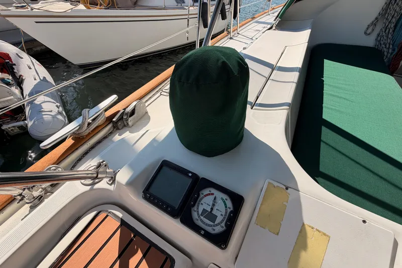 Slide: The Image of Cockpit of 2003 Beneteau Oceanis Clipper 473 with navigation instruments and green cover. - 9