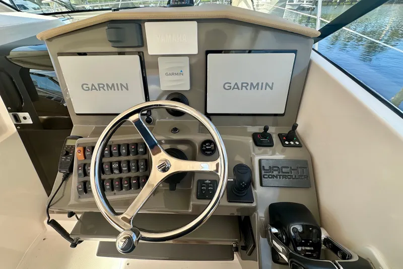 Slide: The Image of Control panel of 2015 Pursuit SC 365i Sport Coupe with Garmin displays and yacht controller. - 17