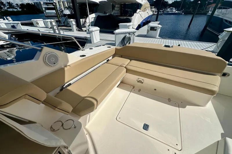 Slide: The Image of 2015 Pursuit SC 365i Sport Coupe interior with beige seating at marina. - 18