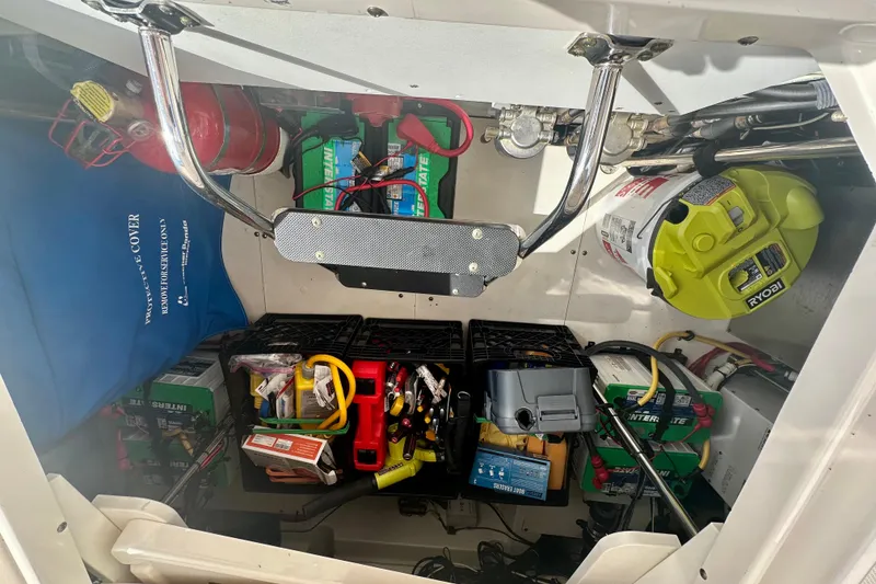 Slide: The Image of 2015 Pursuit SC 365i Sport Coupe engine compartment with tools and equipment storage. - 19
