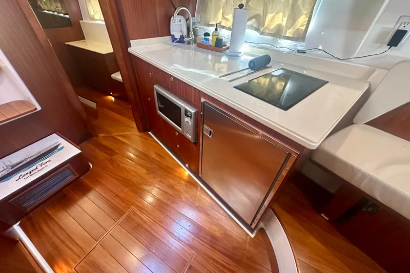 Slide: The Image of Luxurious 2015 Pursuit SC 365i Sport Coupe interior with modern kitchen amenities. - 28