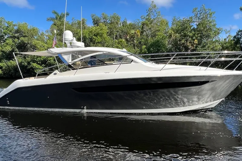 Slide: The Image of 2015 Pursuit SC 365i Sport Coupe yacht cruising on a serene waterway. - 32