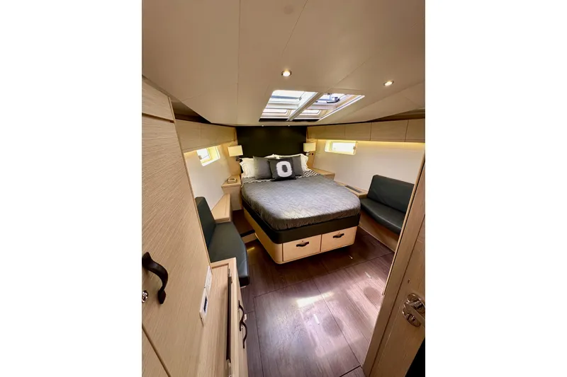 Slide: The Image of Luxurious interior of 2018 Jeanneau 54 yacht with elegant bedding and modern lighting. - 100