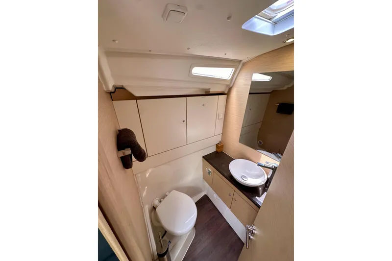 Slide: The Image of Luxurious cabin interior of 2018 Jeanneau 54 yacht with skylight and cozy bedding. - 105