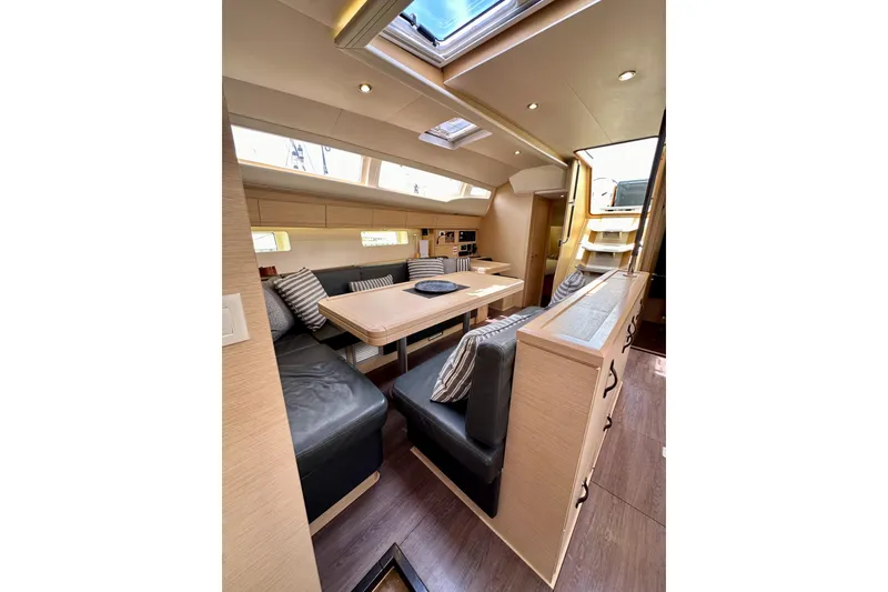 Slide: The Image of Engine compartment of a 2018 Jeanneau 54 sailboat, showcasing mechanical components and storage. - 110