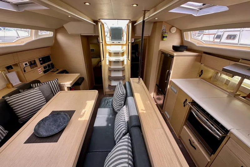 Slide: The Image of Engine compartment of a 2018 Jeanneau 54 sailboat, showcasing mechanical components and wiring. - 111