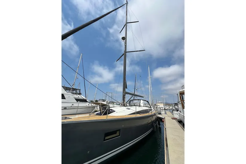 Slide: The Image of 2018 Jeanneau 54 yacht docked at marina under blue sky. - 14