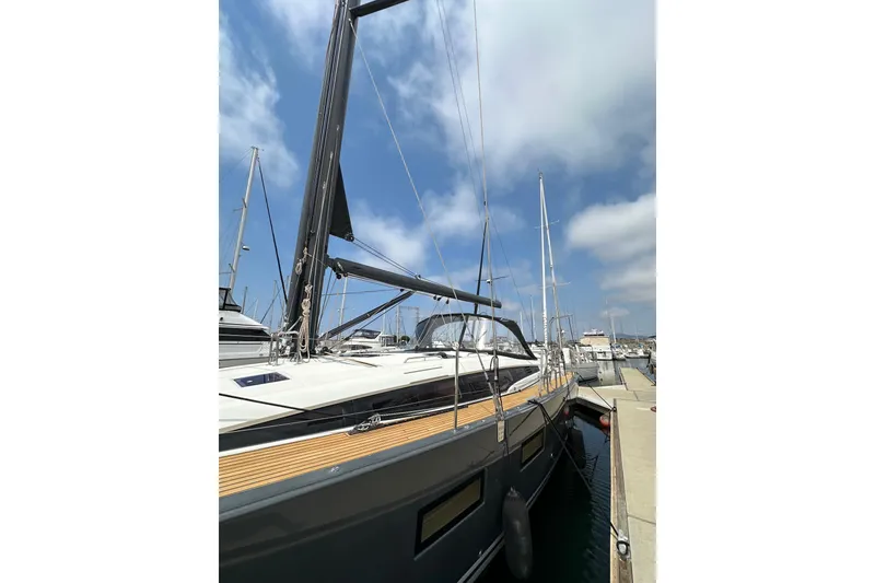 Slide: The Image of 2018 Jeanneau 54 yacht docked at marina under blue sky. - 15