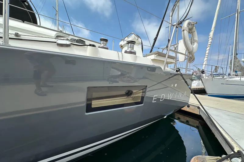 Slide: The Image of 2018 Jeanneau 54 sailboat named Edwina docked at a marina. - 18