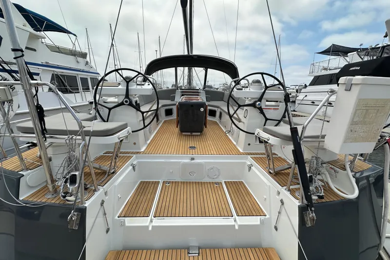 Slide: The Image of 2018 Jeanneau 54 yacht cockpit with dual steering wheels and teak decking. - 22