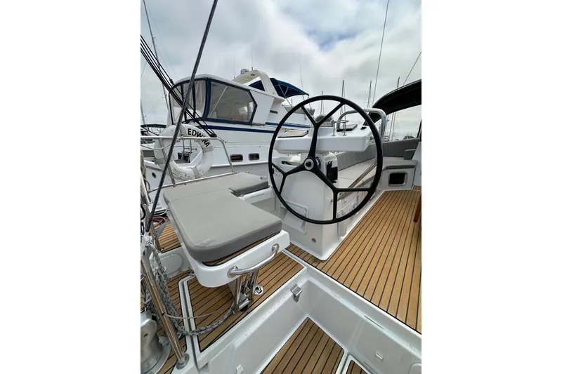 Slide: The Image of 2018 Jeanneau 54 yacht cockpit with steering wheel and teak flooring. - 24