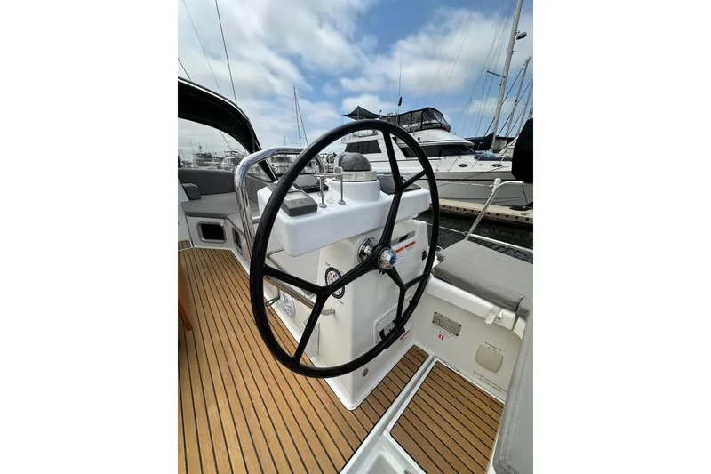 Slide: The Image of Steering wheel of 2018 Jeanneau 54 yacht with teak deck, docked at marina. - 27
