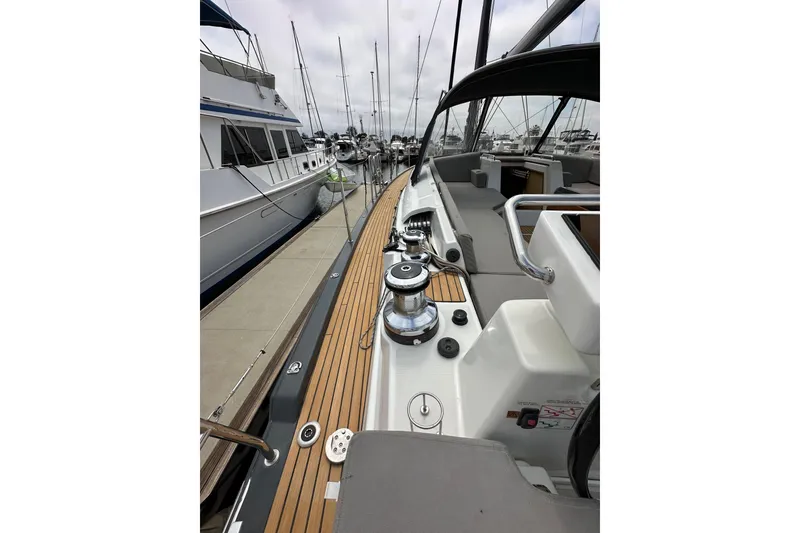 Slide: The Image of 2018 Jeanneau 54 yacht docked, showcasing sleek deck design and modern fittings. - 29