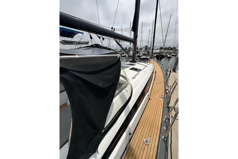 Slide: The Image of 2018 Jeanneau 54 yacht with sleek deck design in marina setting. - 38