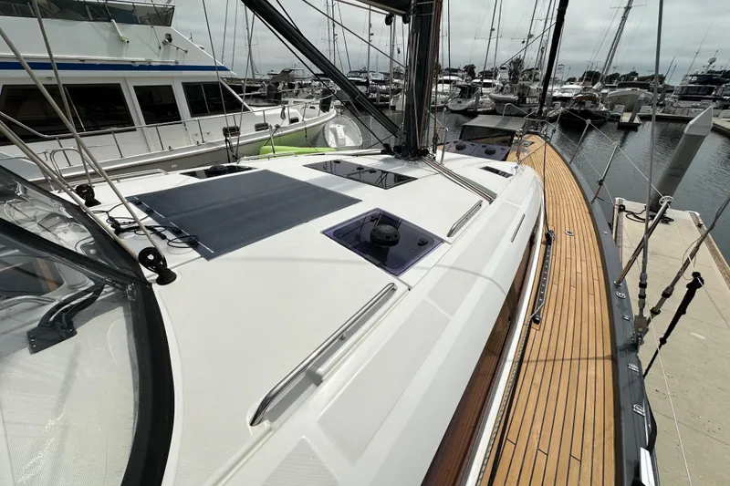 Slide: The Image of 2018 Jeanneau 54 yacht docked, showcasing sleek deck design and modern features. - 40