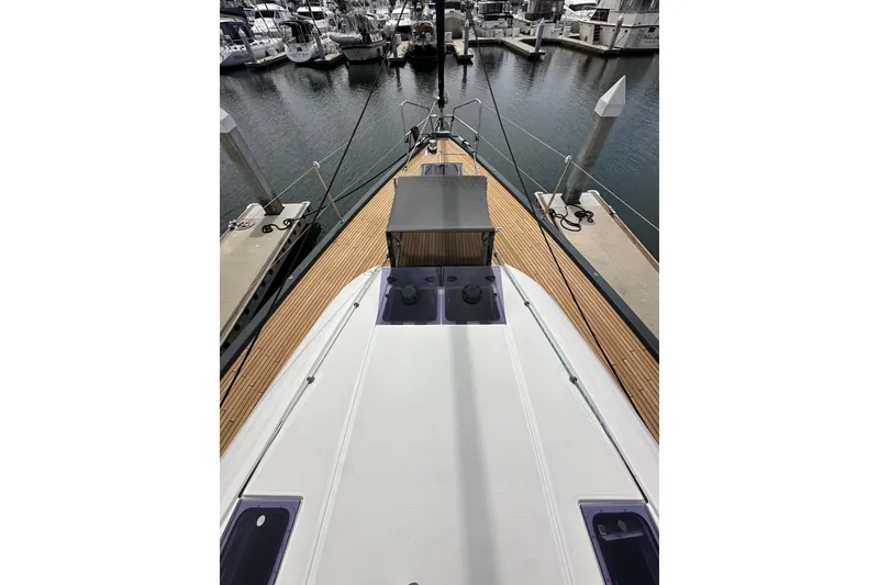 Slide: The Image of 2018 Jeanneau 54 yacht docked at marina, showcasing sleek deck design. - 42