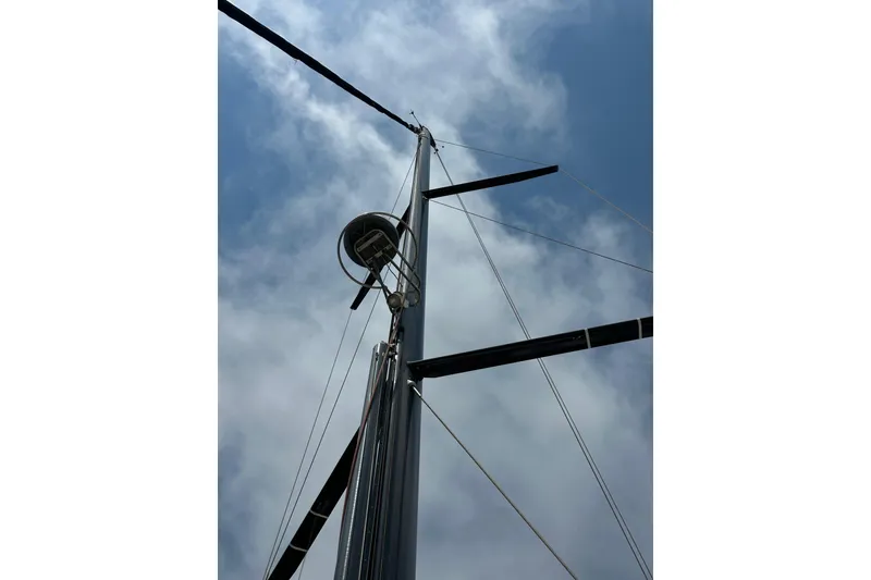 Slide: The Image of 2018 Jeanneau 54 sailboat deck with mast and rigging in marina. - 55