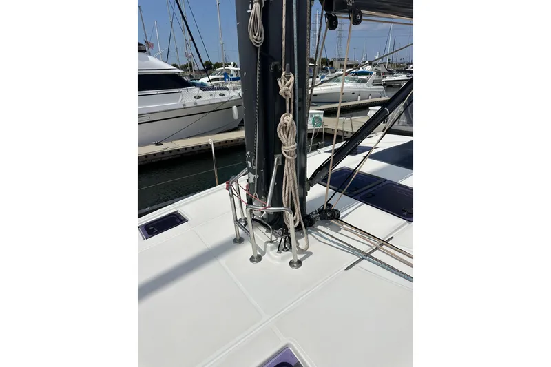 Slide: The Image of 2018 Jeanneau 54 sailboat with cockpit cover, docked at marina. - 56