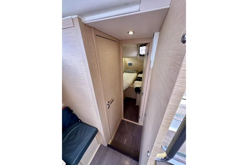 Slide: The Image of Compact bathroom in 2018 Jeanneau 54 yacht with sink, toilet, and storage cabinets. - 68