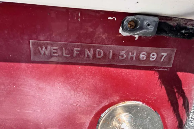 Slide: The Image of 1997 Wellcraft 302 Scarab hull identification number on red surface. - 23