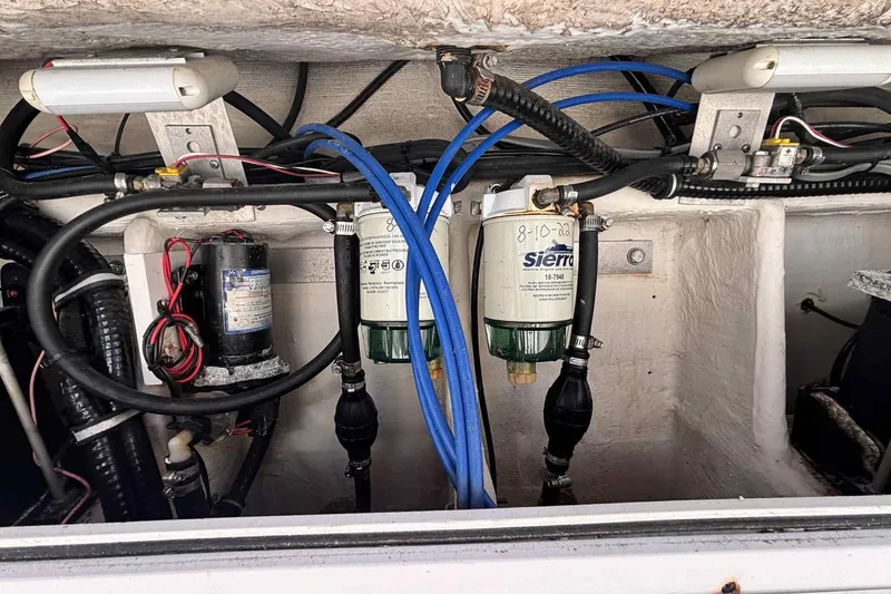 Slide: The Image of Engine compartment of a 1997 Wellcraft 302 Scarab with fuel filters and wiring. - 24