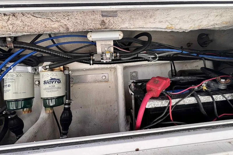 Slide: The Image of Engine compartment of a 1997 Wellcraft 302 Scarab with wiring and fuel filters. - 25