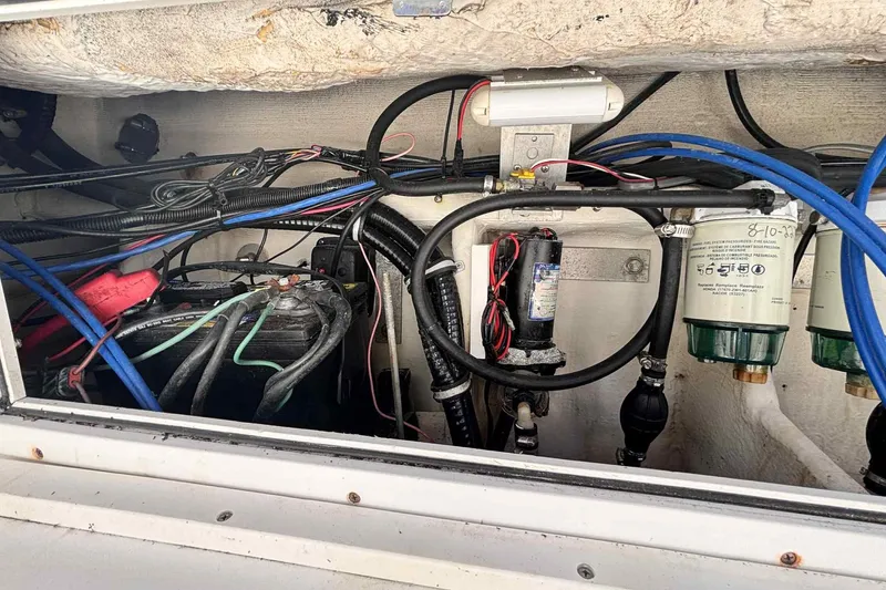 Slide: The Image of Engine compartment of a 1997 Wellcraft 302 Scarab with wiring and filters visible. - 26