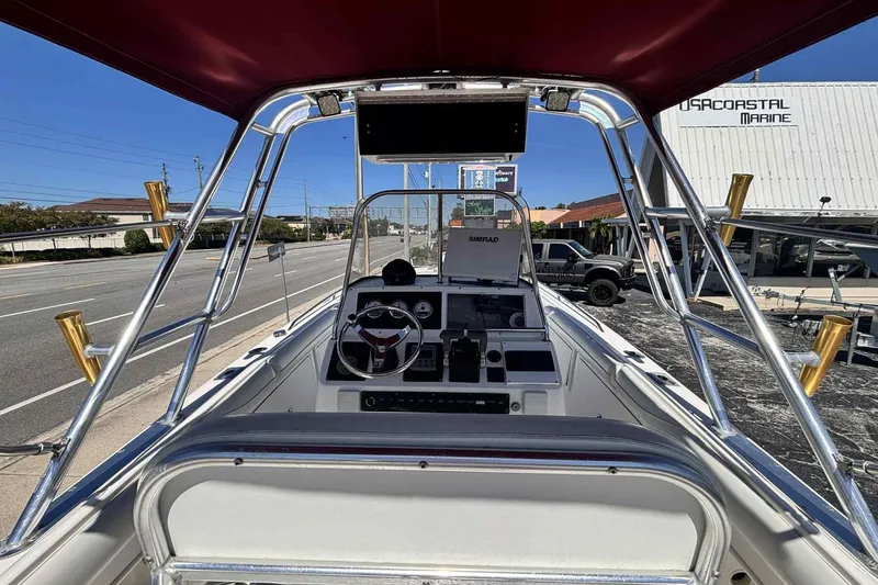 Slide: The Image of 1997 Wellcraft 302 Scarab boat cockpit with steering wheel and navigation equipment. - 29
