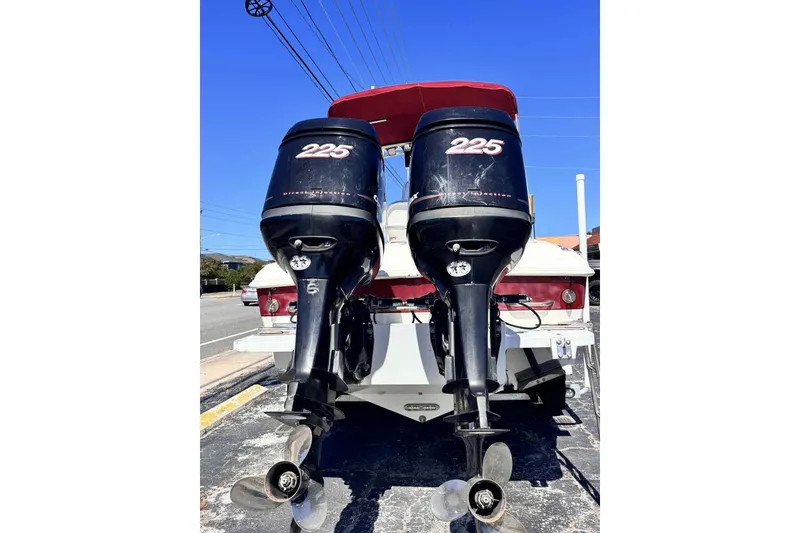 Slide: The Image of 1997 Wellcraft 302 Scarab with dual Mercury outboard engines on open water. - 3