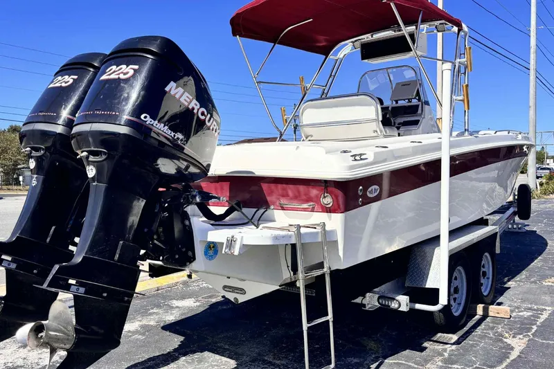 Slide: The Image of 1997 Wellcraft 302 Scarab boat with twin Mercury 225 engines on a trailer. - 31