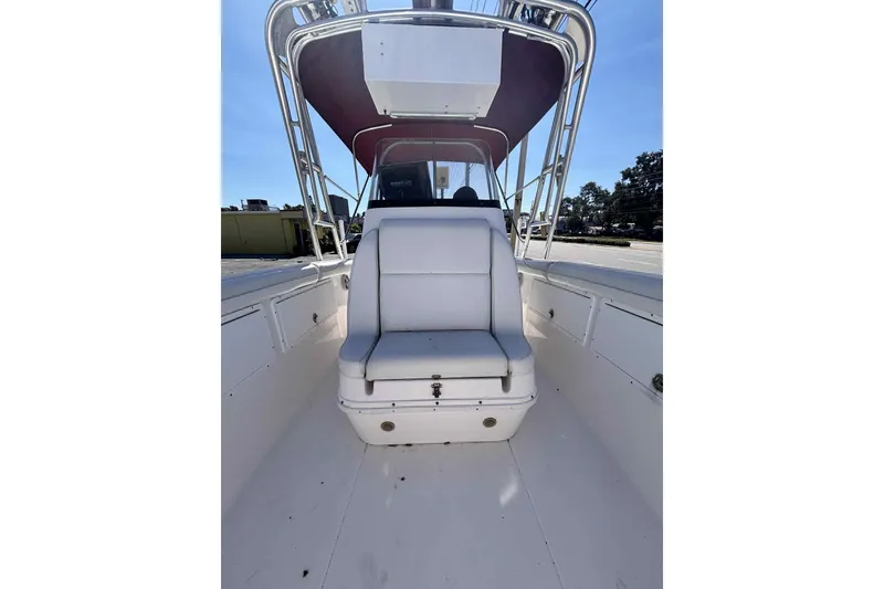 Slide: The Image of 1997 Wellcraft 302 Scarab boat interior with white seating and canopy. - 32