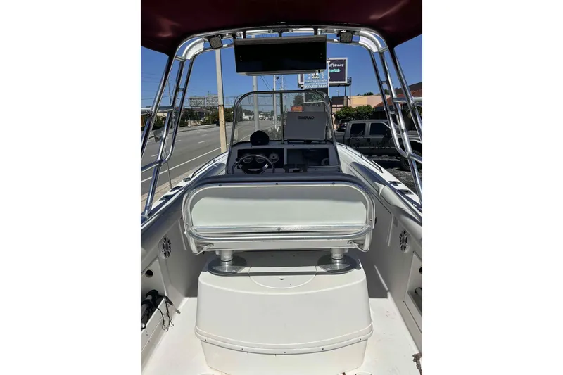 Slide: The Image of 1997 Wellcraft 302 Scarab boat on calm water, featuring a central seating area. - 6