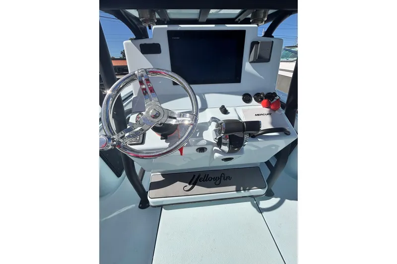 Slide: The Image of 2021 Yellowfin 26 Hybrid boat on calm water, featuring dual engines. - 10