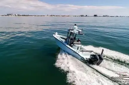 Slide: The Image of 2021 Yellowfin 26 Hybrid boat cruising on open water, clear sky in background. - 13