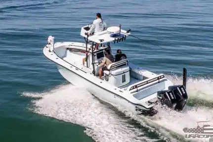 Slide: The Image of 2021 Yellowfin 26 Hybrid boat cruising on open water with passengers onboard. - 15