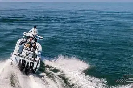 Slide: The Image of 2021 Yellowfin 26 Hybrid boat cruising on open ocean waters. - 19