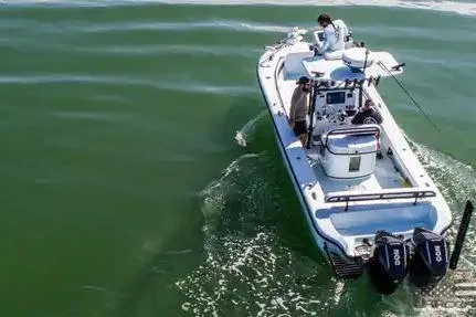 Slide: The Image of 2021 Yellowfin 26 Hybrid boat cruising on open water with dual engines. - 21