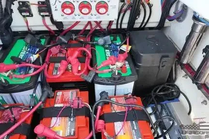 Slide: The Image of Battery setup in a 2021 Yellowfin 26 Hybrid boat, showcasing wiring and connections. - 22