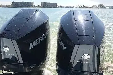 Slide: The Image of Twin Mercury outboard engines on a 2021 Yellowfin 26 Hybrid boat in water. - 24