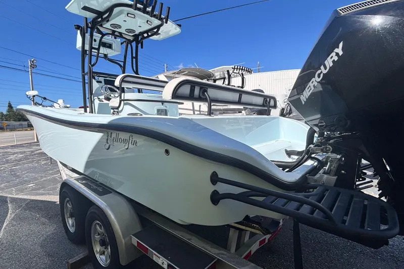 Slide: The Image of 2021 Yellowfin 26 Hybrid boat on trailer with Mercury engine, outdoor display. - 33