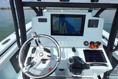 Slide: The Image of 2021 Yellowfin 26 Hybrid boat dashboard with modern navigation equipment and steering wheel. - 36