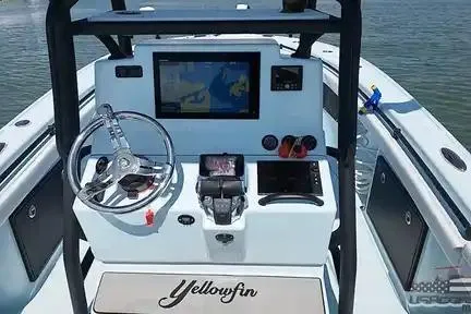 Slide: The Image of 2021 Yellowfin 26 Hybrid boat dashboard with navigation system and steering wheel. - 37