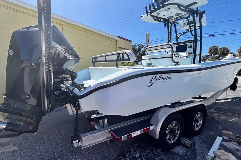 Slide: The Image of 2021 Yellowfin 26 Hybrid boat on calm water, viewed from the front. - 7