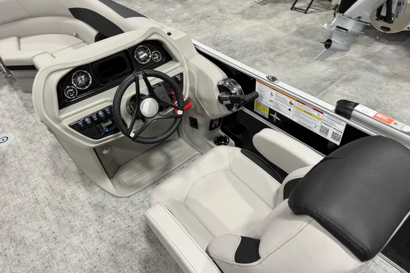 Slide: The Image of Interior of 2026 Berkshire 24 UL LE boat, featuring modern steering and control panel. - 12